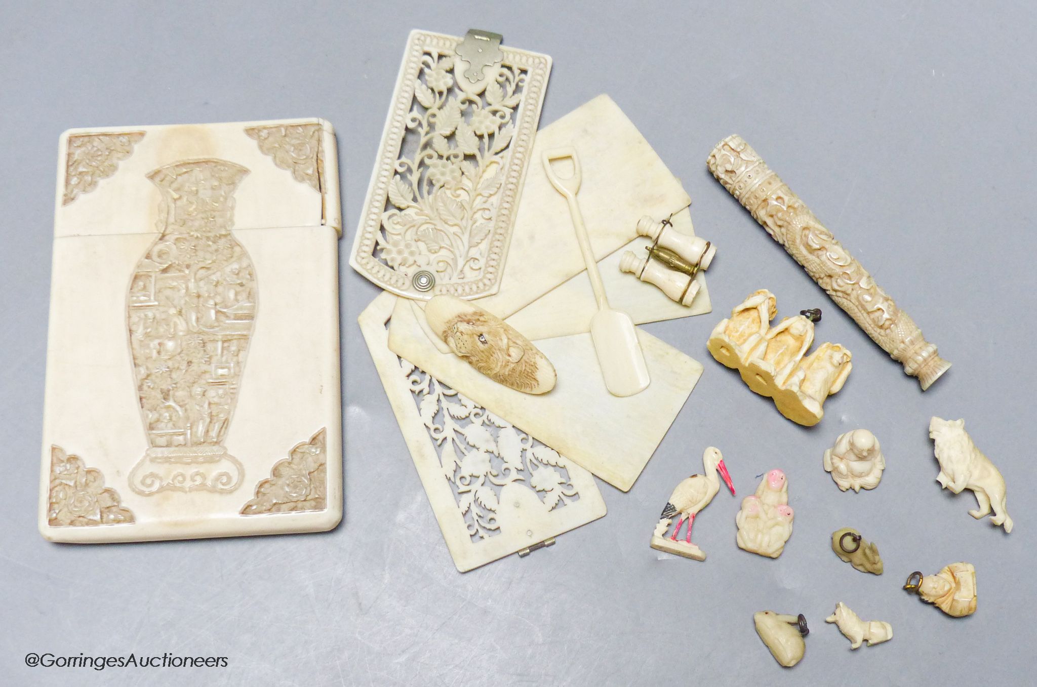 A late 19th century Chinese carved ivory card case, a similar needle case, an aide-memoire and sundries